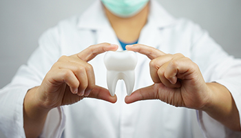 male dentist smiling with patient on background