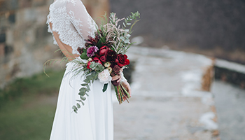 Women in wedding dress holding flowers